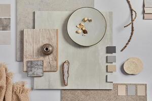 Creative flat lay design of stylish beige architect moodboard composition with samples of building, textile and natural materials and personal accessories. Top view - white background photo