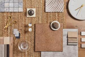 Flat lay of creative architect moodboard composition with samples of building, orange textile and natural materials and personal accessories. Top view, template. photo