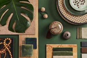Stylish flat lay composition of creative architect moodboard design with samples of building, textile and natural materials and personal accessories. Top view, green background, template. photo