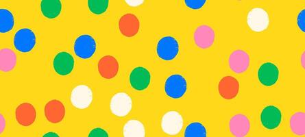 Whimsical seamless polka dot pattern with playful crayon spots and colorful confetti. Primary colored design for party or carnival yellow background. vector