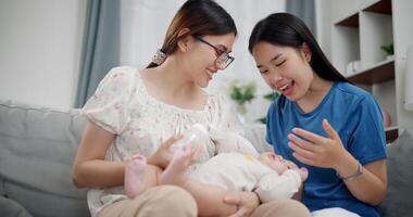 Portrait of Happy family having fun with little son on sofa in the living room. Enjoying fun time together, Multi-generation family photo