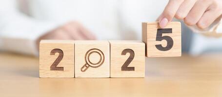 2025 block with magnifying glass icon. SEO, Search Engine Optimization, hiring , Advertising, Idea, Strategy, marketing, Keyword, Content and New Year start concepts photo