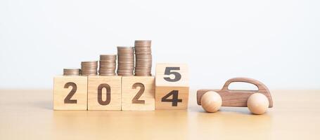 2024 end year to Happy New Year 2025 with car model and Coins Money stack for deposit and Automobile Tax. Money Saving, Car Insurance, Financial, vehicle Repair and Maintenance and New Year concept photo