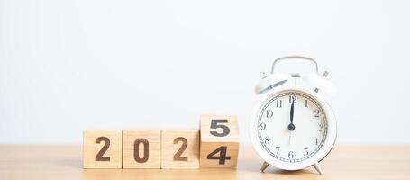 2024 end year to Happy New Year 2025 with vintage alarm clock. Christmas, New Start, Resolution, countdown, Goals, Plan, Action and Motivation Concept photo