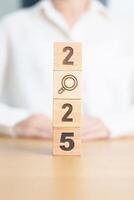 2025 block with magnifying glass icon. SEO, Search Engine Optimization, hiring , Advertising, Idea, Strategy, marketing, Keyword, Content and New Year start concepts photo