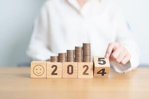 2024 end year to Happy New Year 2025 with Coins stack and Smile icon. goal, Money, Budget, investment, financial, savings, New Year Resolution, Satisfaction, feedback, Review and good year concept photo
