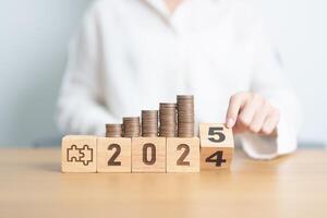 2024 end year to Happy New Year 2025 with Coins stack and jigsaw puzzle icon. business Process, Team, teamwork, Strategy, goal, Money, Budget, investment, financial and New Year Resolution concept photo