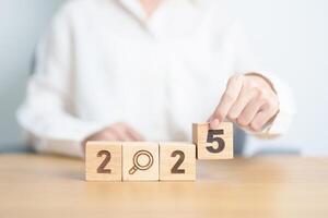 2025 block with magnifying glass icon. SEO, Search Engine Optimization, hiring , Advertising, Idea, Strategy, marketing, Keyword, Content and New Year start concepts photo