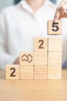 2025 year block with jigsaw puzzle icon. Business Process, Team, teamwork, Goal, mission, Resolution, strategy, plan, Action, partnership, and New Year start photo