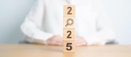 2025 block with magnifying glass icon. SEO, Search Engine Optimization, hiring , Advertising, Idea, Strategy, marketing, Keyword, Content and New Year start concepts photo