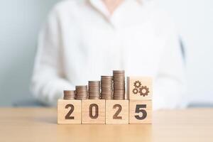 Happy New Year 2025 with Coins stack and gear icon. business Process, Team, teamwork, Strategy, goal, Money, Budget, investment, financial and New Year Resolution concept photo