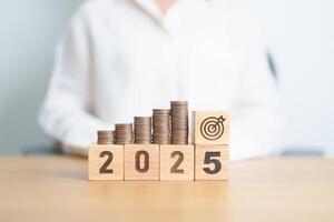 Happy New Year 2025 with Coins stack and dartboard icon. Strategy, goal, Money, Budget, tax, investment, financial, savings and New Year Resolution concepts photo
