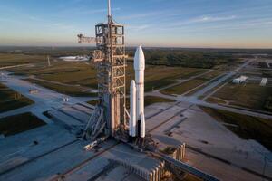 Falcon heavy rocket is standing on a launchpad, ready for taking off photo