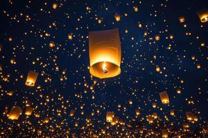 Hundreds of paper lanterns floating in the night sky with a big one in the foreground photo