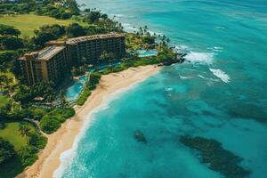 Turquoise ocean water lapping on the beach in front of a resort photo
