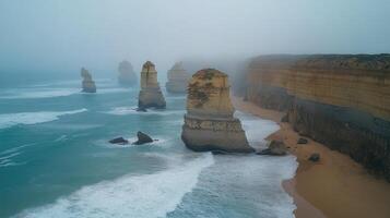 Fog rolling in over the twelve apostles on a stormy day photo