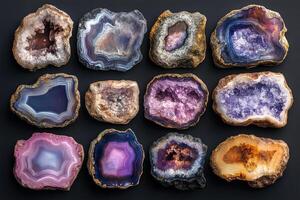 Collection of colorful polished agate slices showing natural patterns on black background photo
