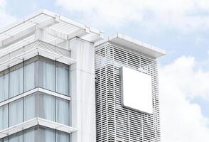 Mock up white light box billboard on tower building. Clipping path for mockup photo