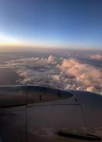Golden sunset sky with fluffy ornamental clouds, panoramic view from an airplane photo