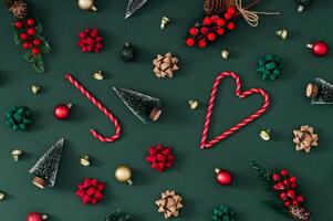 Trendy Christmas pattern made of various winter and Xmas objects on green background. Minimal creative Christmas and New Year concept. Festive holiday pattern backdrop. Christmas aesthetic. Flat lay. photo