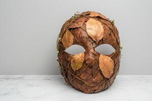 Autumn leaves mask on white background photo