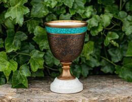 Ornate decorative chalice in garden setting photo