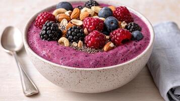 Healthy and colorful smoothie bowl with fresh berries and nuts photo