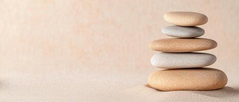 Balanced zen stones on sandy beach photo