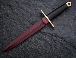 Sleek and Dangerous Dagger on Dark Slate Background photo
