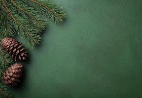 Festive pine branches and pine cones on green background photo