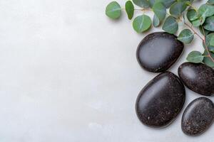 Relaxing spa stones and eucalyptus leaves photo