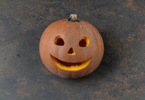 Carved pumpkin with smiling jack o lantern face photo