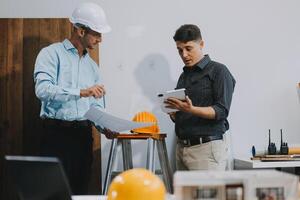 Team Engineers with draft plan of building on constructing site. Engineer work on site. engineer visit and inspection site engineer. Inspector engineer check and working on site. photo