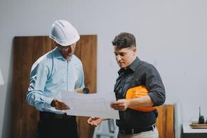 Team Engineers with draft plan of building on constructing site. Engineer work on site. engineer visit and inspection site engineer. Inspector engineer check and working on site. photo