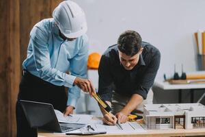 Team Engineers with draft plan of building on constructing site. Engineer work on site. engineer visit and inspection site engineer. Inspector engineer check and working on site. photo