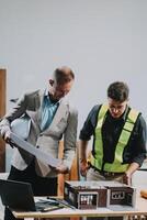 Team Engineers with draft plan of building on constructing site. Engineer work on site. engineer visit and inspection site engineer. Inspector engineer check and working on site. photo