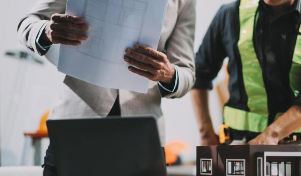 Team Engineers with draft plan of building on constructing site. Engineer work on site. engineer visit and inspection site engineer. Inspector engineer check and working on site. photo