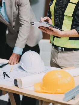 Team Engineers with draft plan of building on constructing site. Engineer work on site. engineer visit and inspection site engineer. Inspector engineer check and working on site. photo