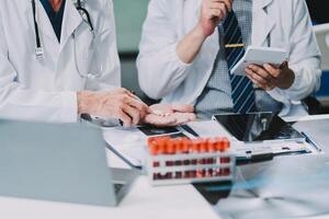 Group of medical practitioners working together and analyzing medical scan in the hospital photo