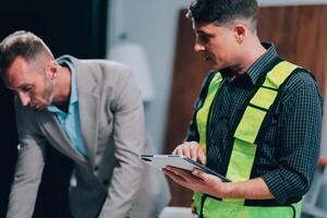 Team Engineers with draft plan of building on constructing site. Engineer work on site. engineer visit and inspection site engineer. Inspector engineer check and working on site. photo