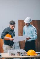 Team Engineers with draft plan of building on constructing site. Engineer work on site. engineer visit and inspection site engineer. Inspector engineer check and working on site. photo