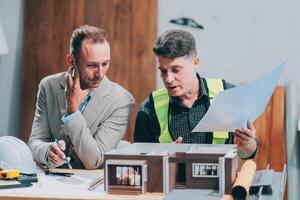 Team Engineers with draft plan of building on constructing site. Engineer work on site. engineer visit and inspection site engineer. Inspector engineer check and working on site. photo