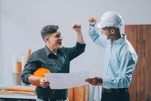 Team Engineers with draft plan of building on constructing site. Engineer work on site. engineer visit and inspection site engineer. Inspector engineer check and working on site. photo