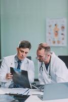Group of medical practitioners working together and analyzing medical scan in the hospital photo