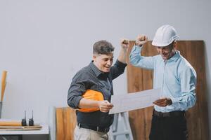 Team Engineers with draft plan of building on constructing site. Engineer work on site. engineer visit and inspection site engineer. Inspector engineer check and working on site. photo