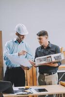 Team Engineers with draft plan of building on constructing site. Engineer work on site. engineer visit and inspection site engineer. Inspector engineer check and working on site. photo