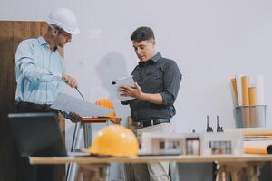 Team Engineers with draft plan of building on constructing site. Engineer work on site. engineer visit and inspection site engineer. Inspector engineer check and working on site. photo
