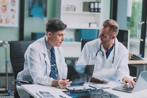 Group of medical practitioners working together and analyzing medical scan in the hospital photo