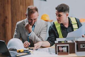 Team Engineers with draft plan of building on constructing site. Engineer work on site. engineer visit and inspection site engineer. Inspector engineer check and working on site. photo