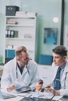 Group of medical practitioners working together and analyzing medical scan in the hospital photo